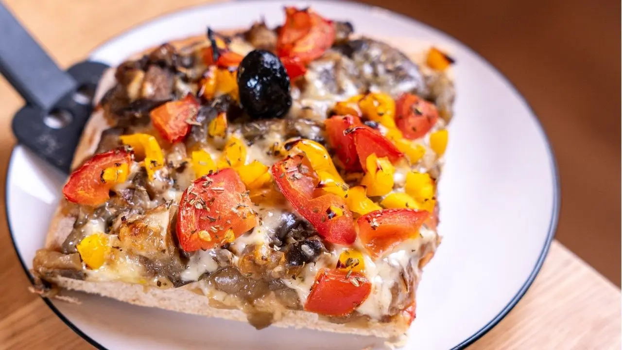 Part de pizza garnie de poivrons et d’olives